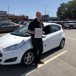 Student hoding their driving test certificate